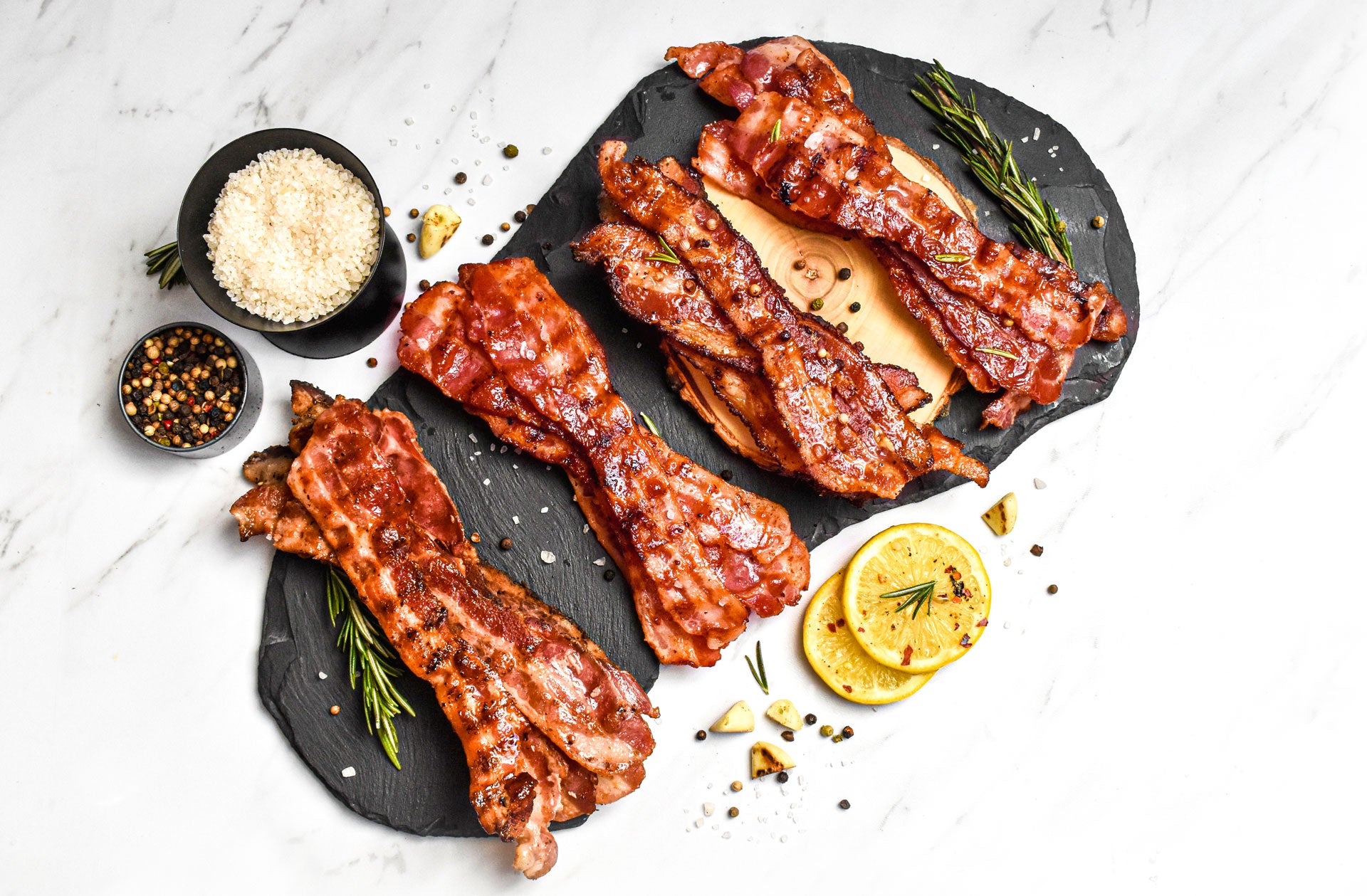 bacon sampler presented on wood and slate boards