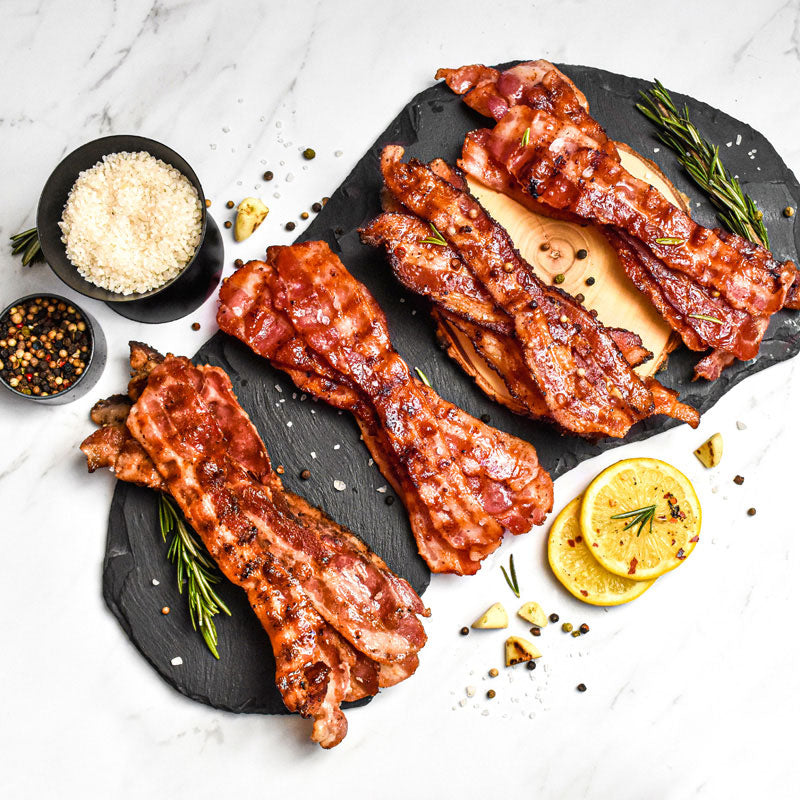 bacon sampler presented on wood and slate boards