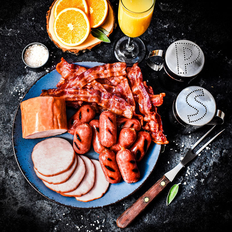 breakfast trio bundle on a blue plate served with salt pepper and orange juice