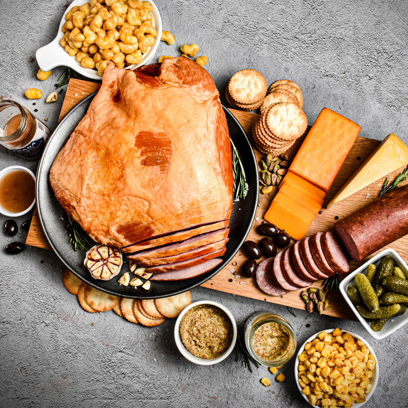 components of the charcuterie essentials bundle displayed on a cutting board