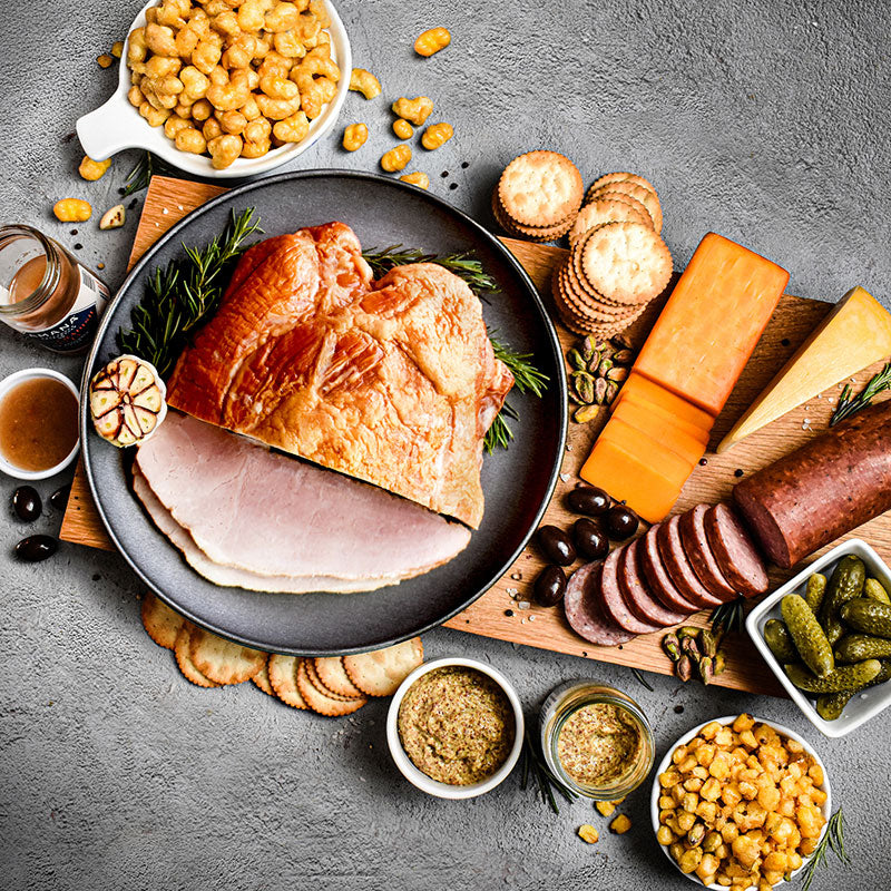 components of the charcuterie essentials bundle displayed on a cutting board