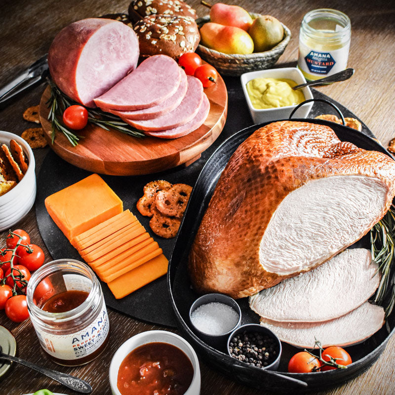 truket and ham combo on wooden tray served with cheese relish and mustard