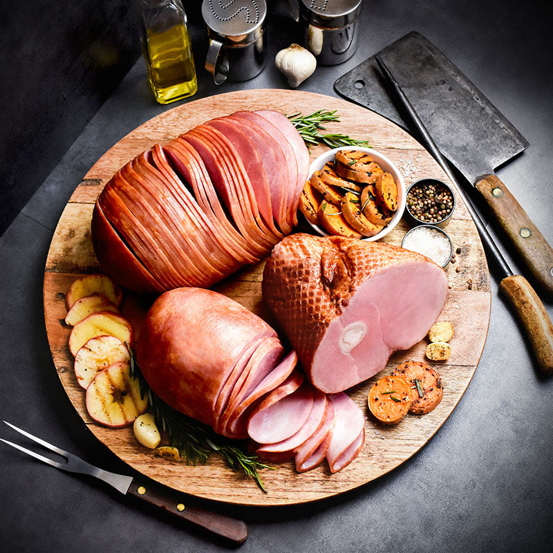 amana ham sampler partially sliced on a wooden serving tray