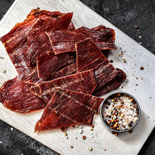 pile of beef jerky with salt and pepper