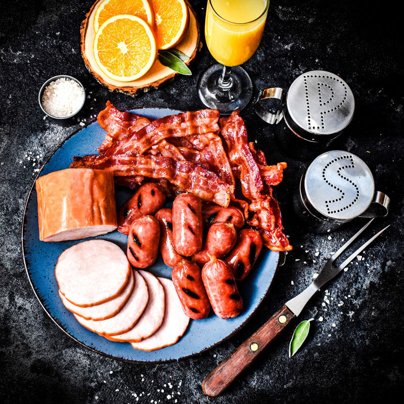 breakfast trio bundle on a blue plate served with salt pepper and orange juice