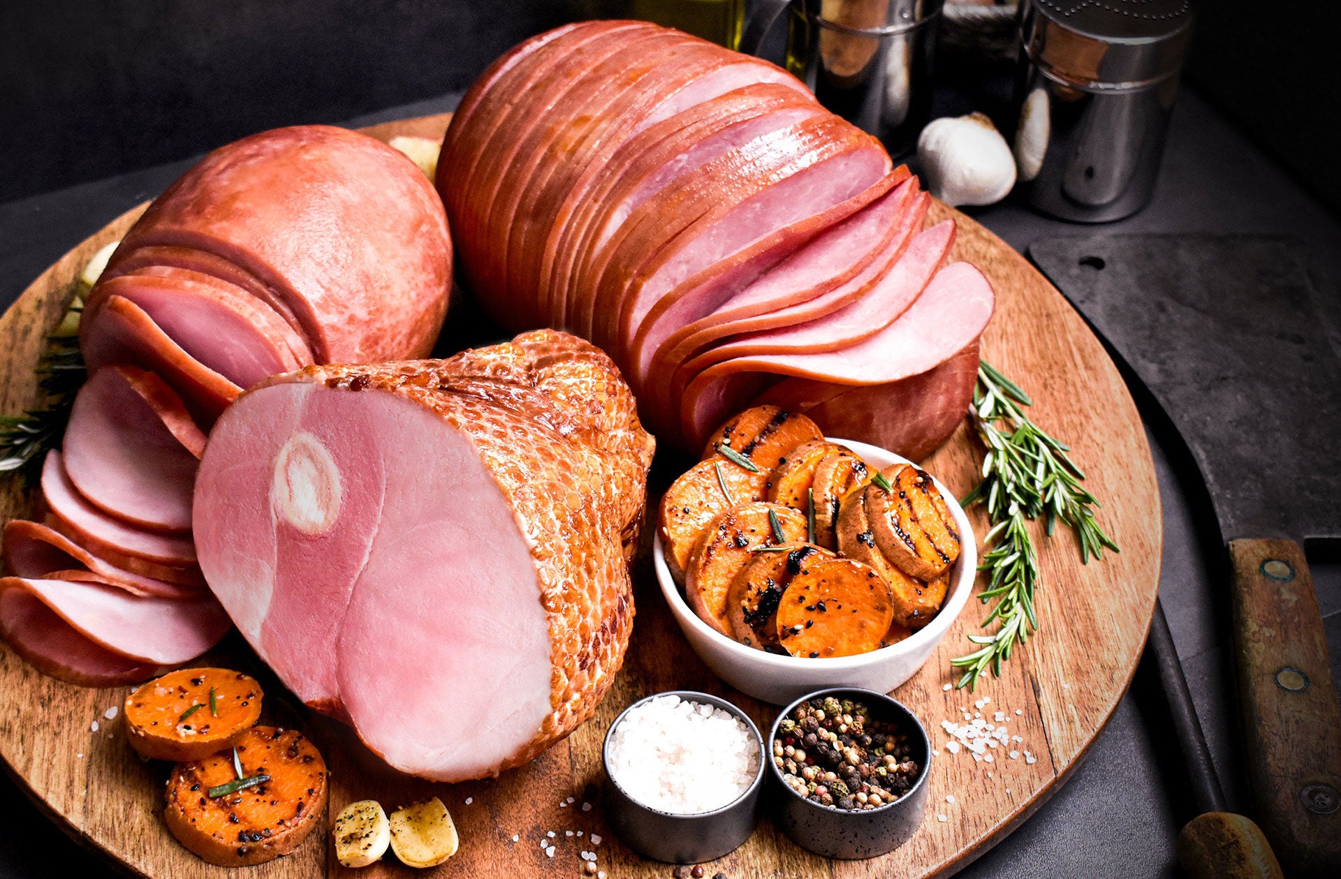 amana ham sampler partially sliced on a wooden serving tray