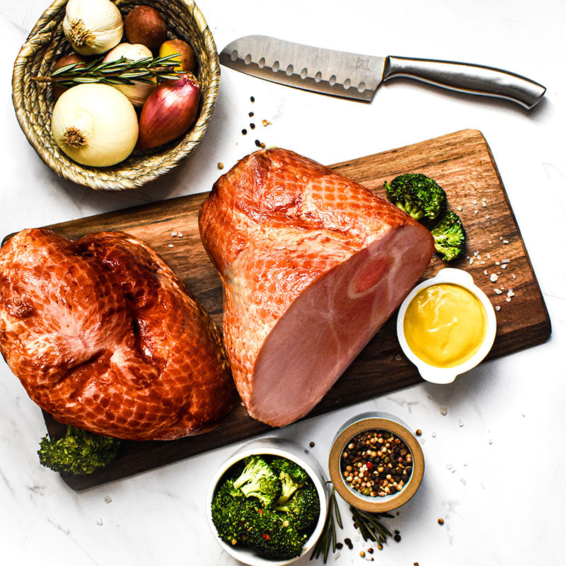 lil bon-in ham on a cutting board surrounded by vegetables