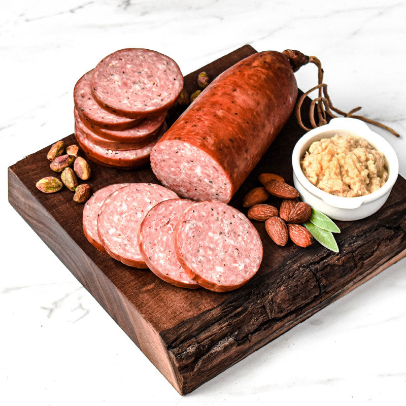 old world summer sausage on a wooden cutting board