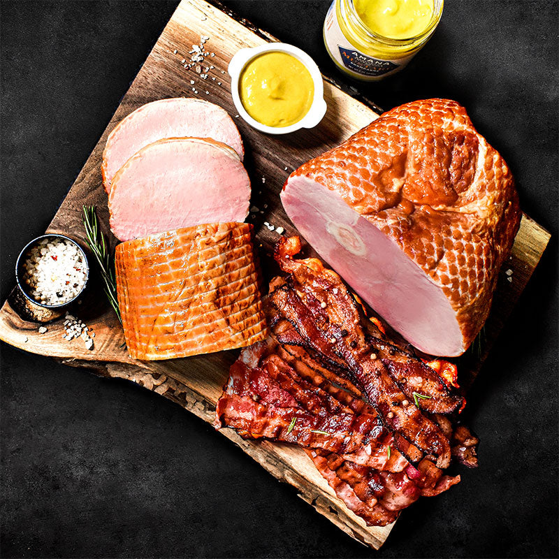 pork lovers trio on a wood slab with mustard