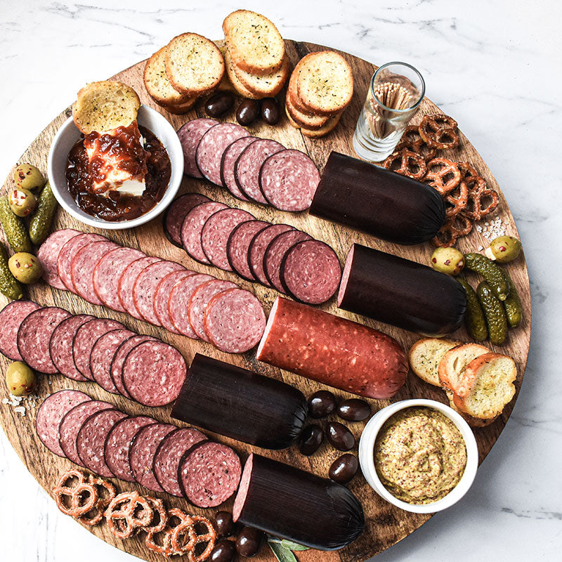 sausage 5 pack sliced and spread out on a wooden serving tray