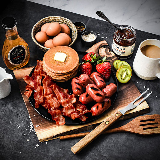 sunrise special displayed on black plate with pancakes and fruit