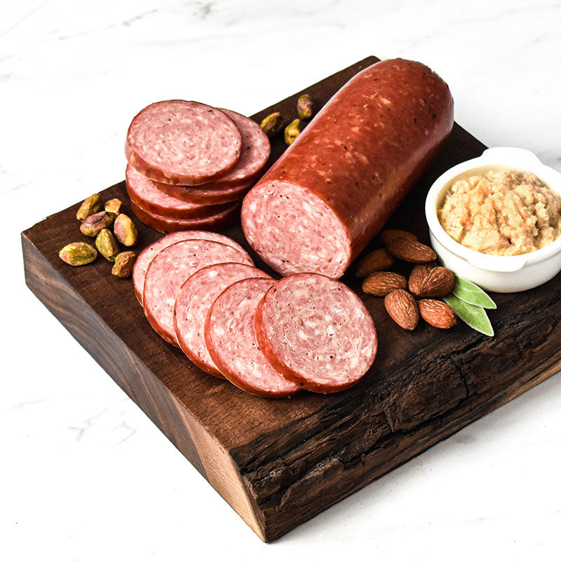 traditional smoked sausage on top of a wooden cutting board