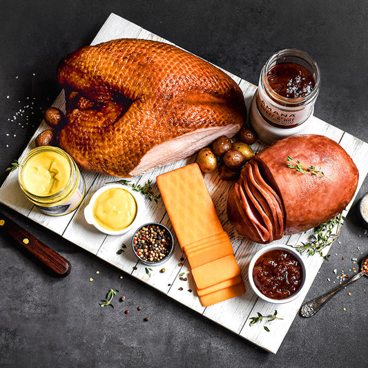 truket and ham combo on wooden tray served with cheese relish and mustard